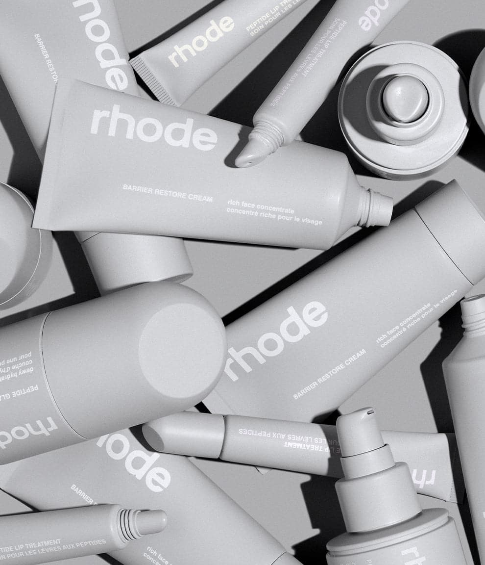 large pile of rhode products, including: peptide glazing fluid, barrier restore cream & peptide lip treament